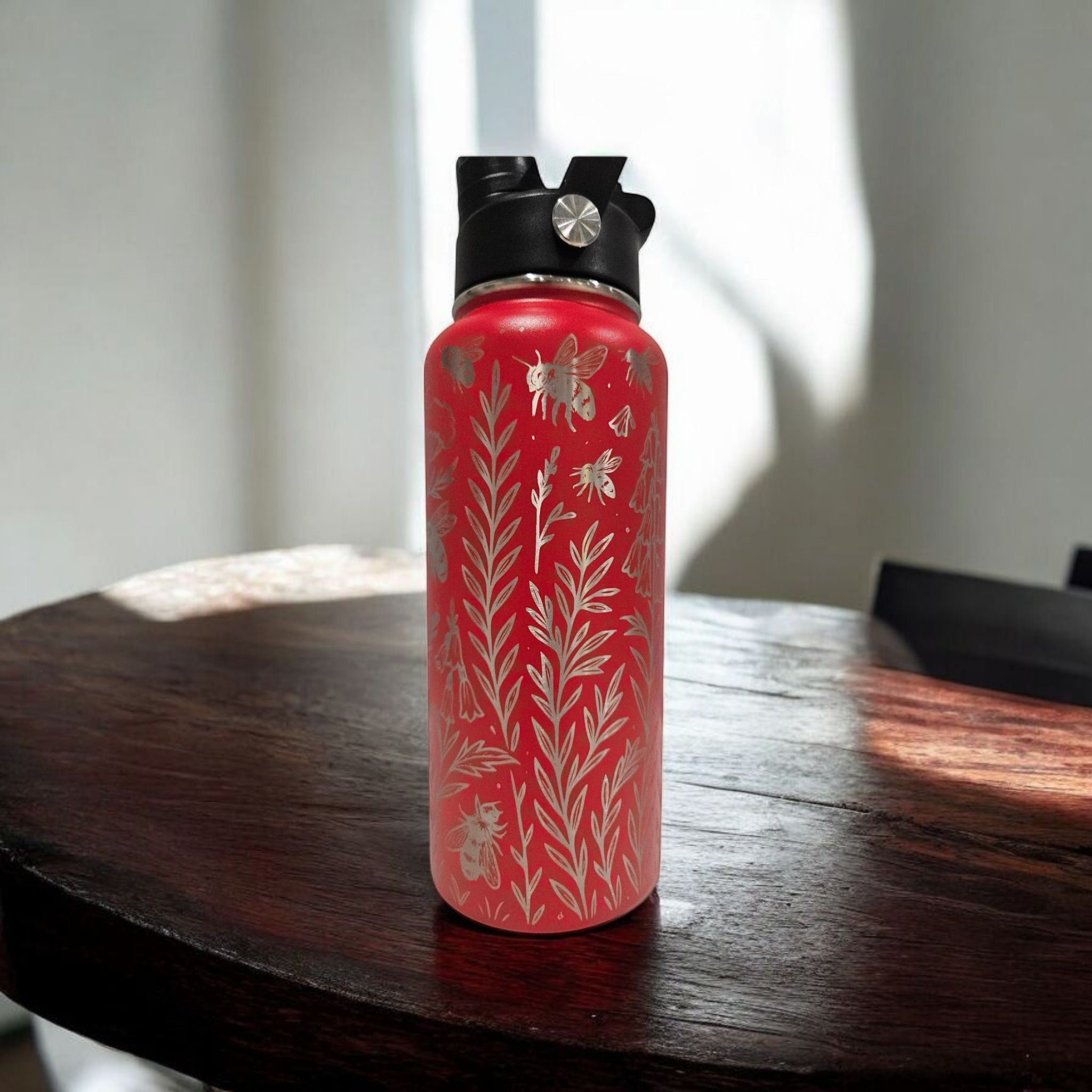 Red 32oz stainless steel water bottle with full wrap laser engraved wildflower design, insulated