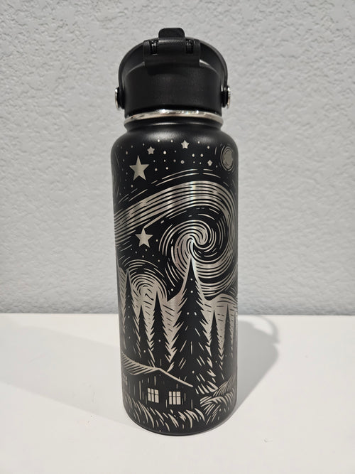 Black 32oz hydro water bottle with full engraved  designs on a silver background