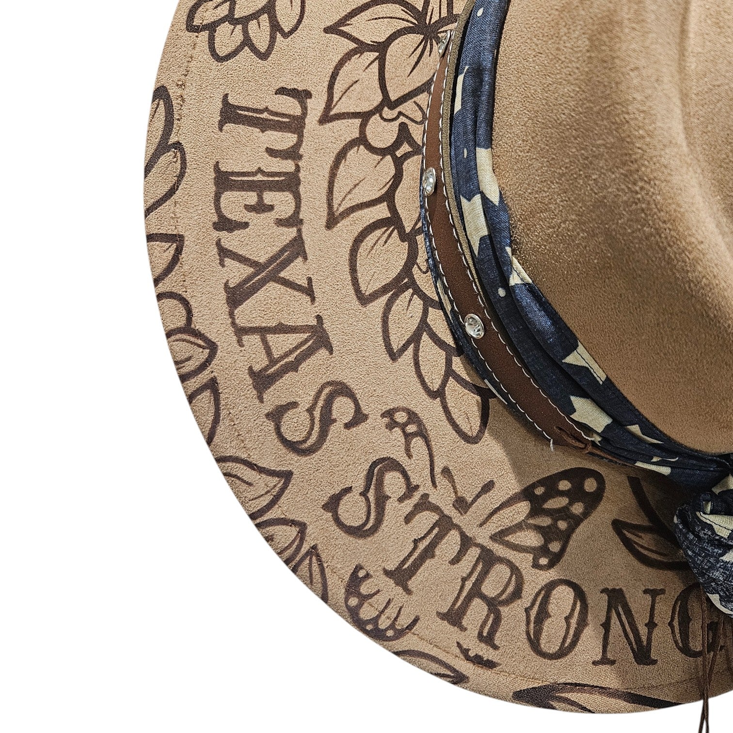 Close-up of Texas Strong text laser engraved on left side of Camel rancher hat