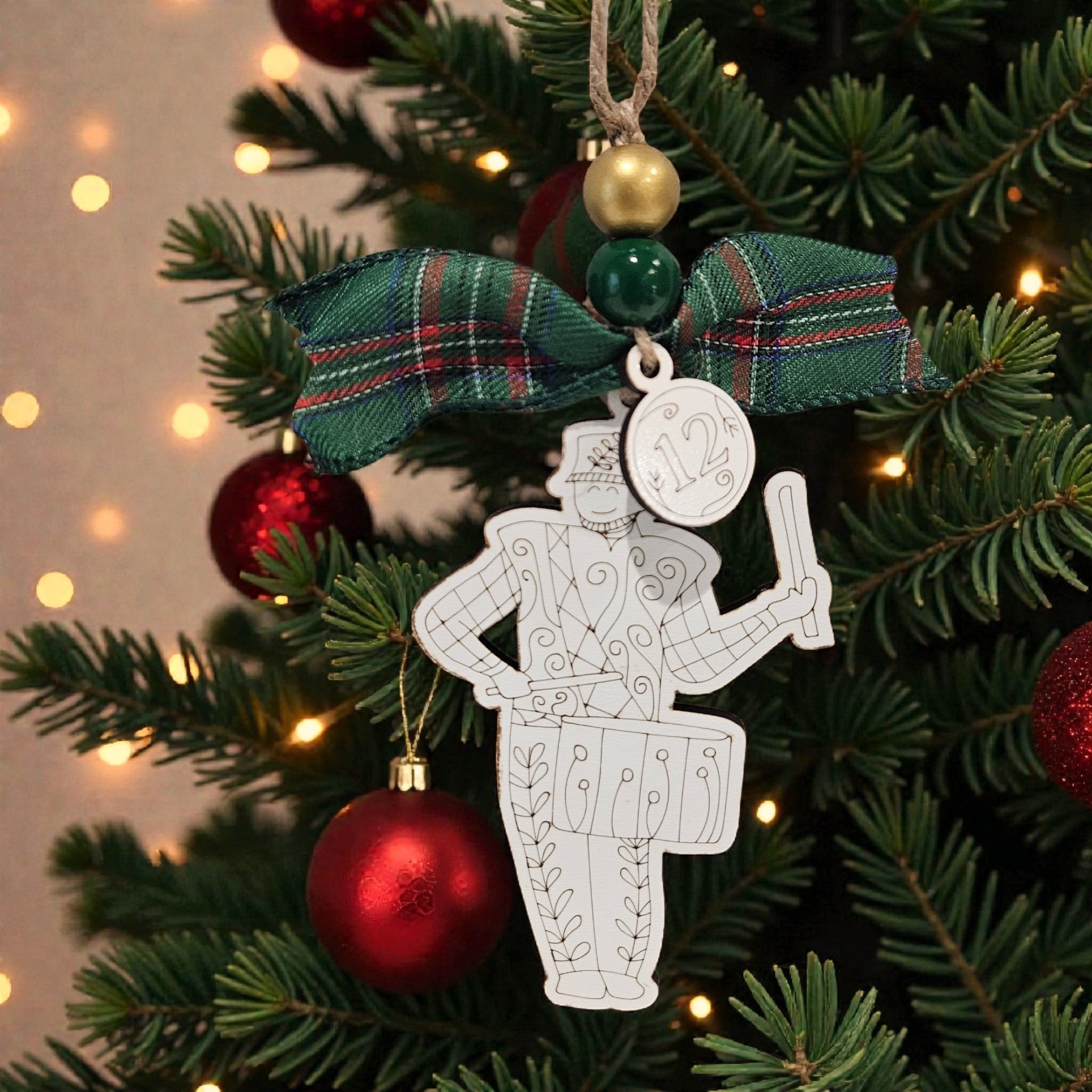 Day 12: “Day 12 twelve drummers drumming engraved white wood ornament hanging on Christmas tree with bow and bead.