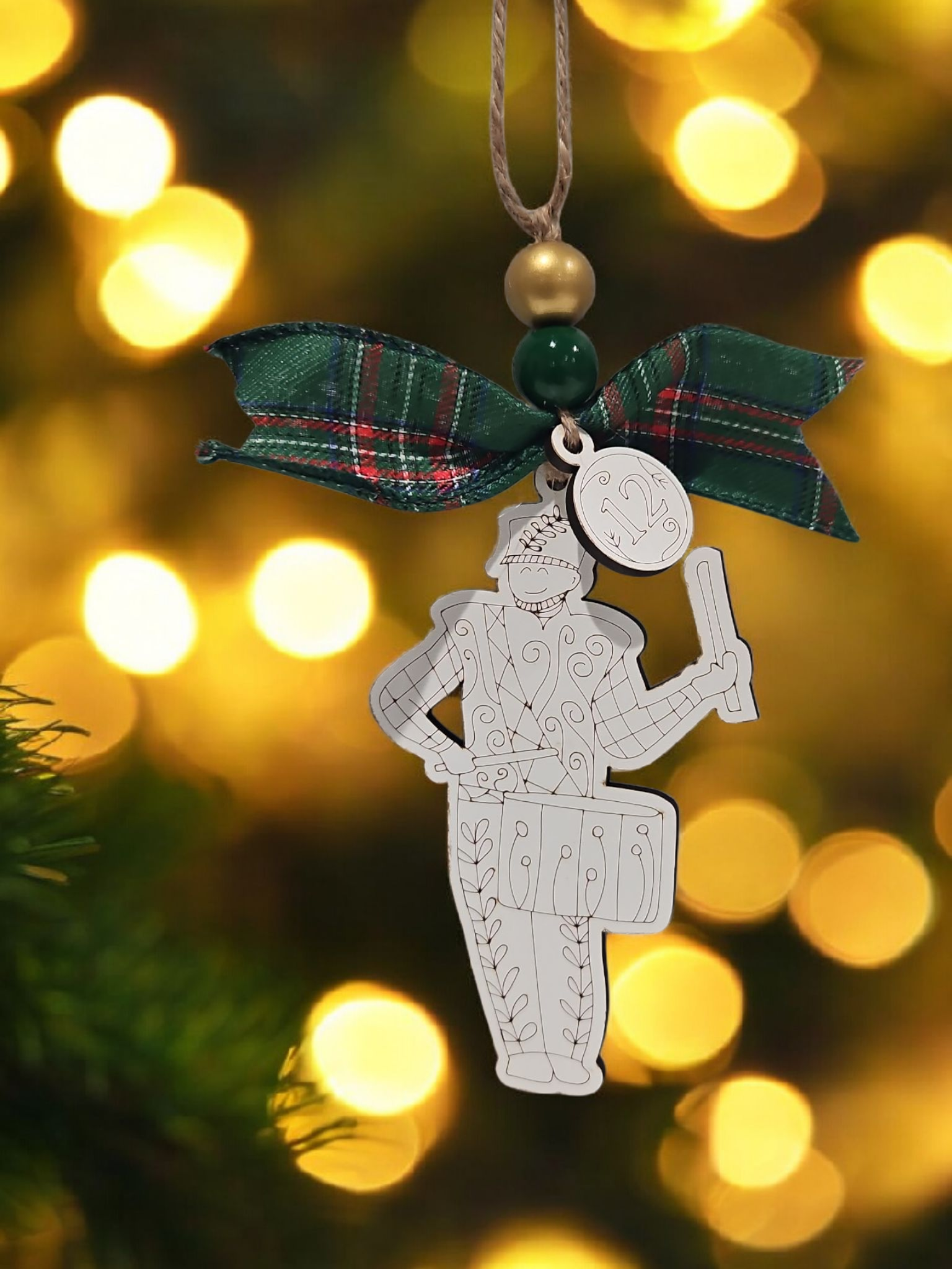 Day 12 twelve drummers drumming engraved white wood Christmas ornament hanging on Christmas tree with bow and bead
