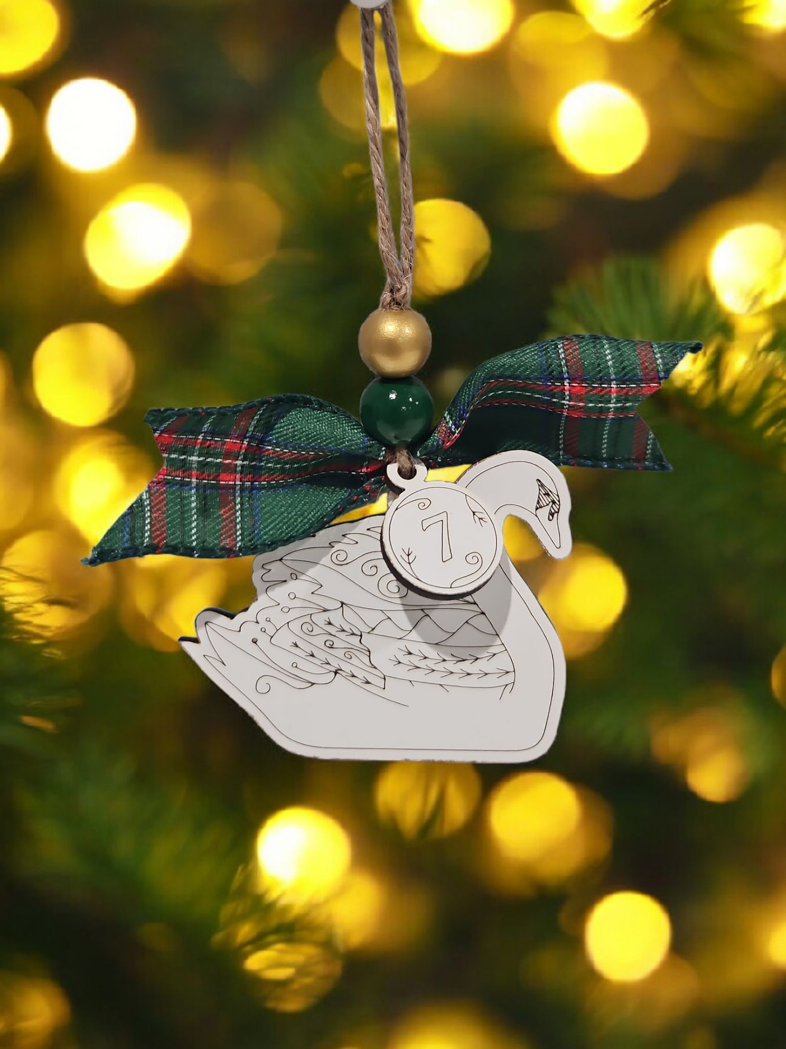 Day 7 seven swans a-swimming engraved white wood Christmas ornament hanging on Christmas tree with bow and bead