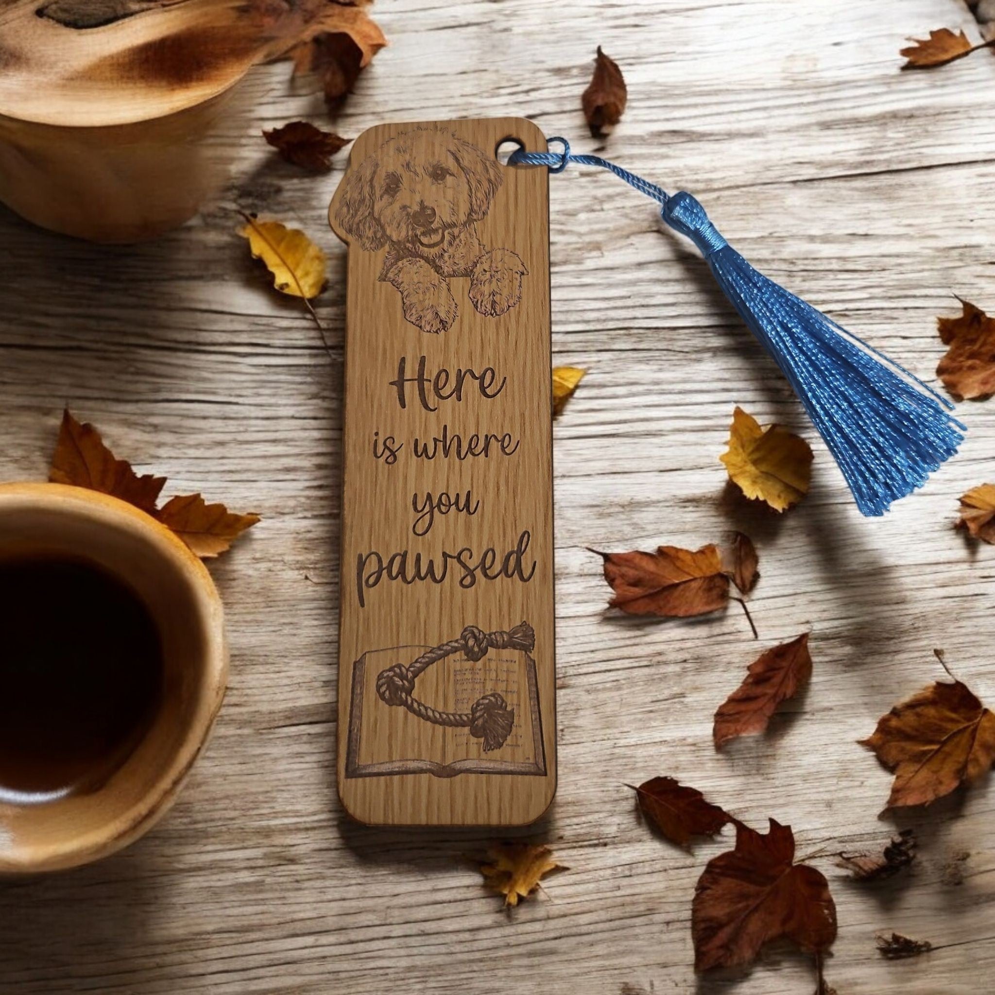 Oak wood bookmark featuring a laser engraved labradoodle with a blue tassel, 5.75 by 3.75 inches, 1/8 inch thick