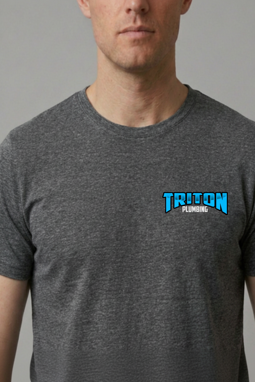 A man wearing a dark heather gray crewneck t-shirt with a blue and white 'TRITON PLUMBING' logo on the left chest, set against a plain gray background.
