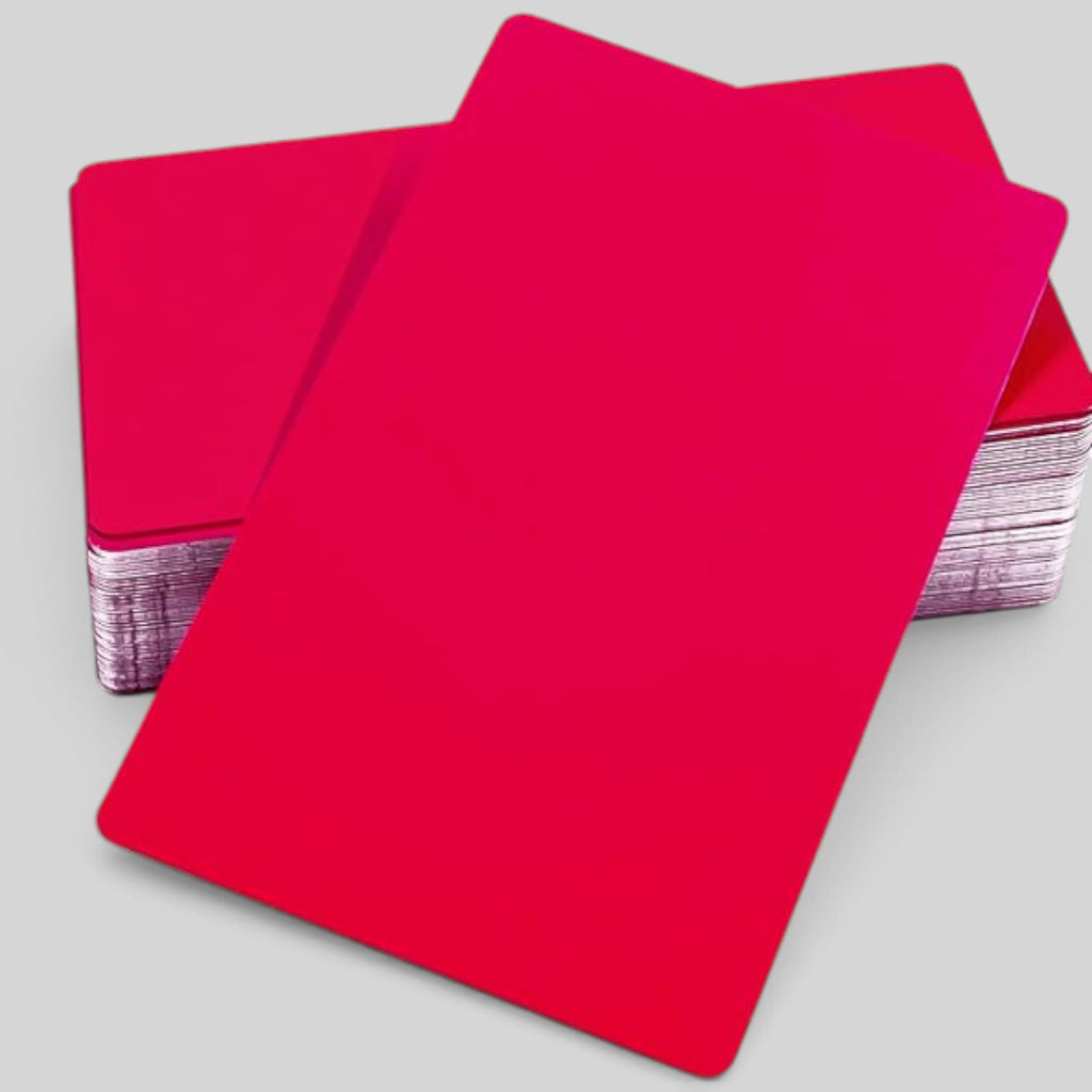 A stack of solid red metal cards arranged diagonally on a light gray background.