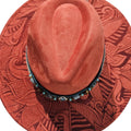Top view of rusty red teardrop wide brim hat with organic geometric laser engraved design and teal fabric hat band with blue beaded jute accent